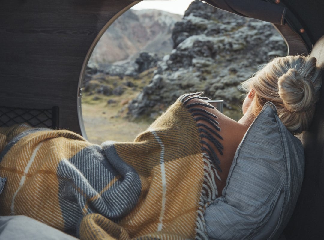girl in tent with a blanket