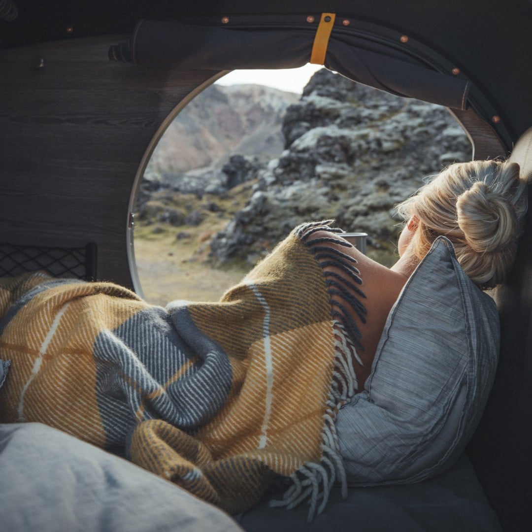 woman in a tent with warm blanket