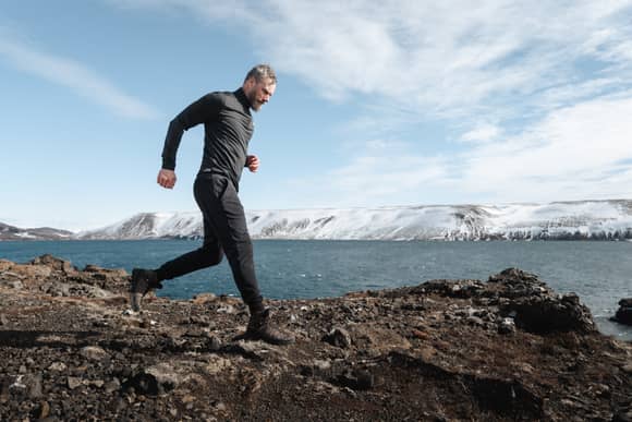 man running by the Icelandic sea