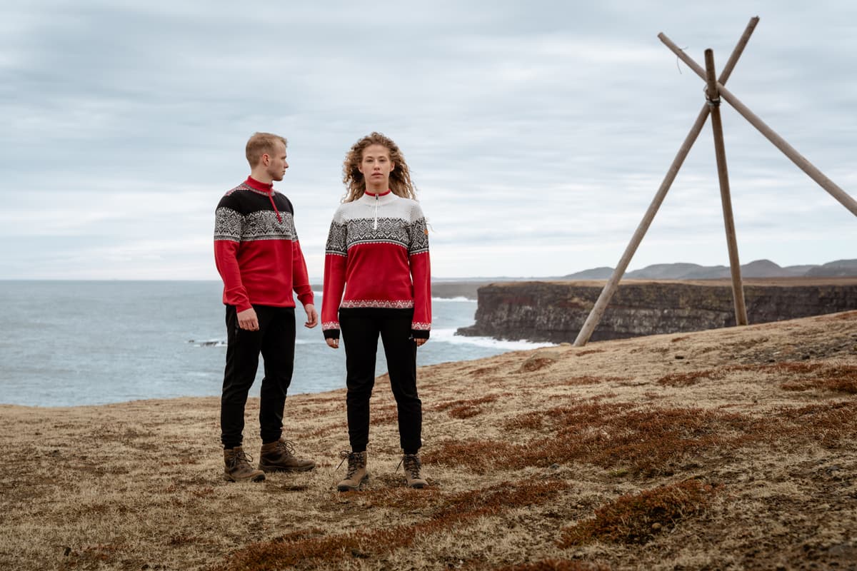 couple wearing Norwegian sweater by the sea