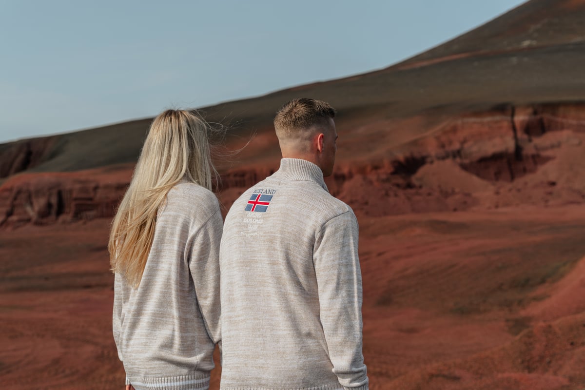couple walking in red sand nature in Vest Iceland