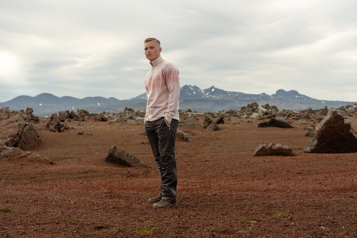 man wearing merino wool sweater in rocky nature
