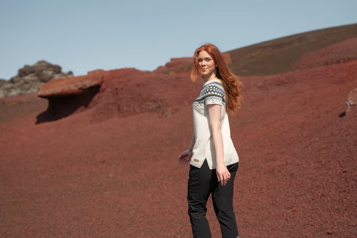 woman walking in red sand in Snæfellsnes, in west Iceland