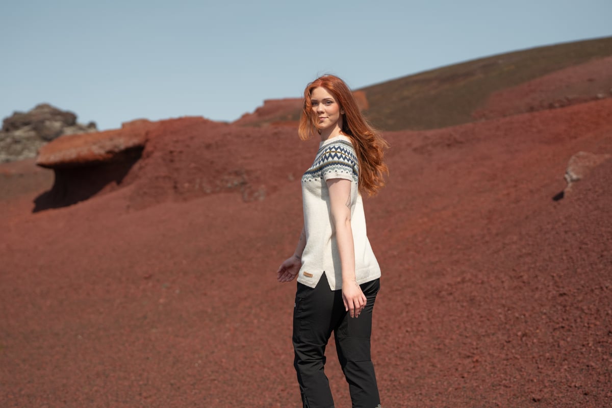 woman walking in red sand in Snæfellsnes, in west Iceland