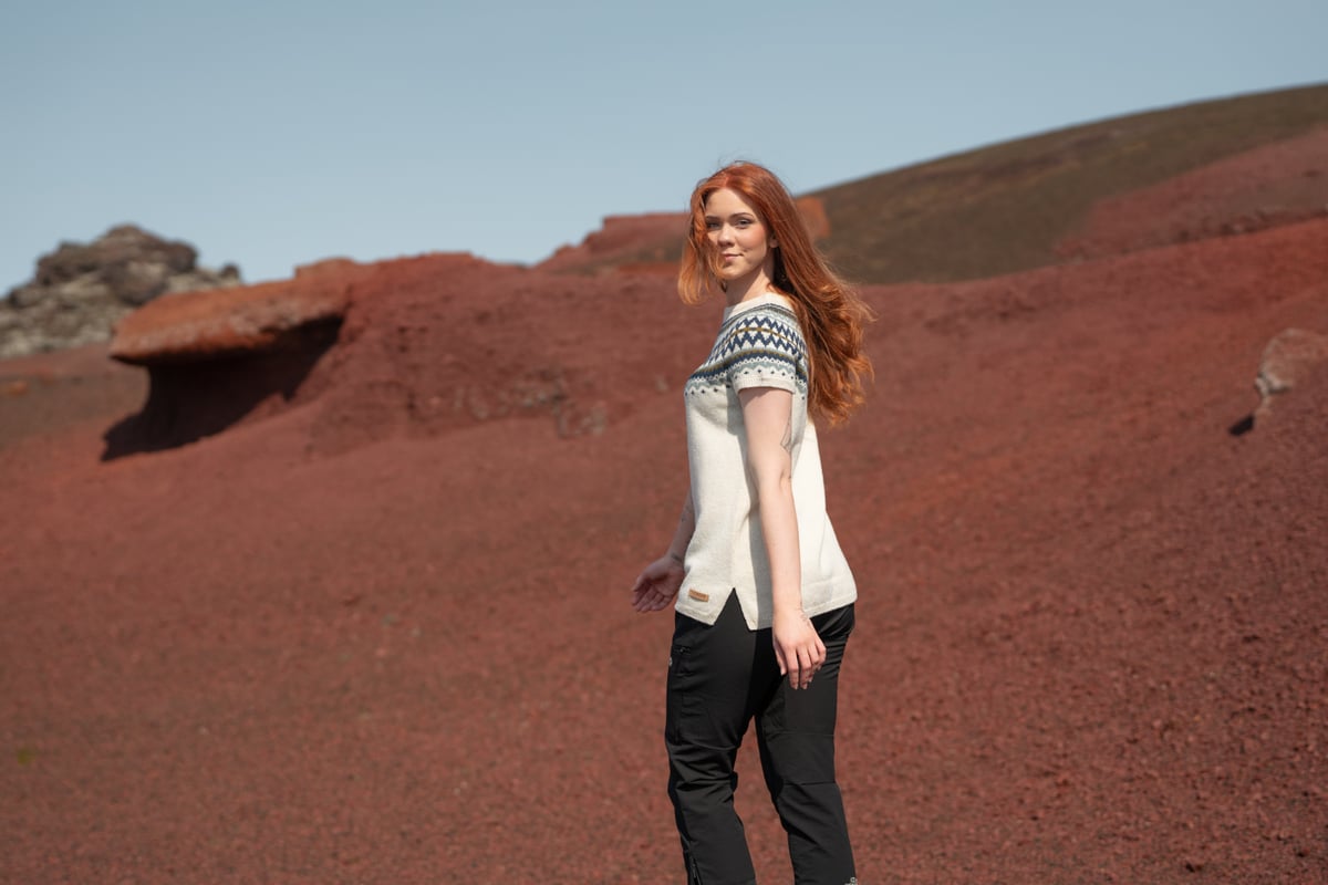 woman walking in red sand in Snæfellsnes, in west Iceland