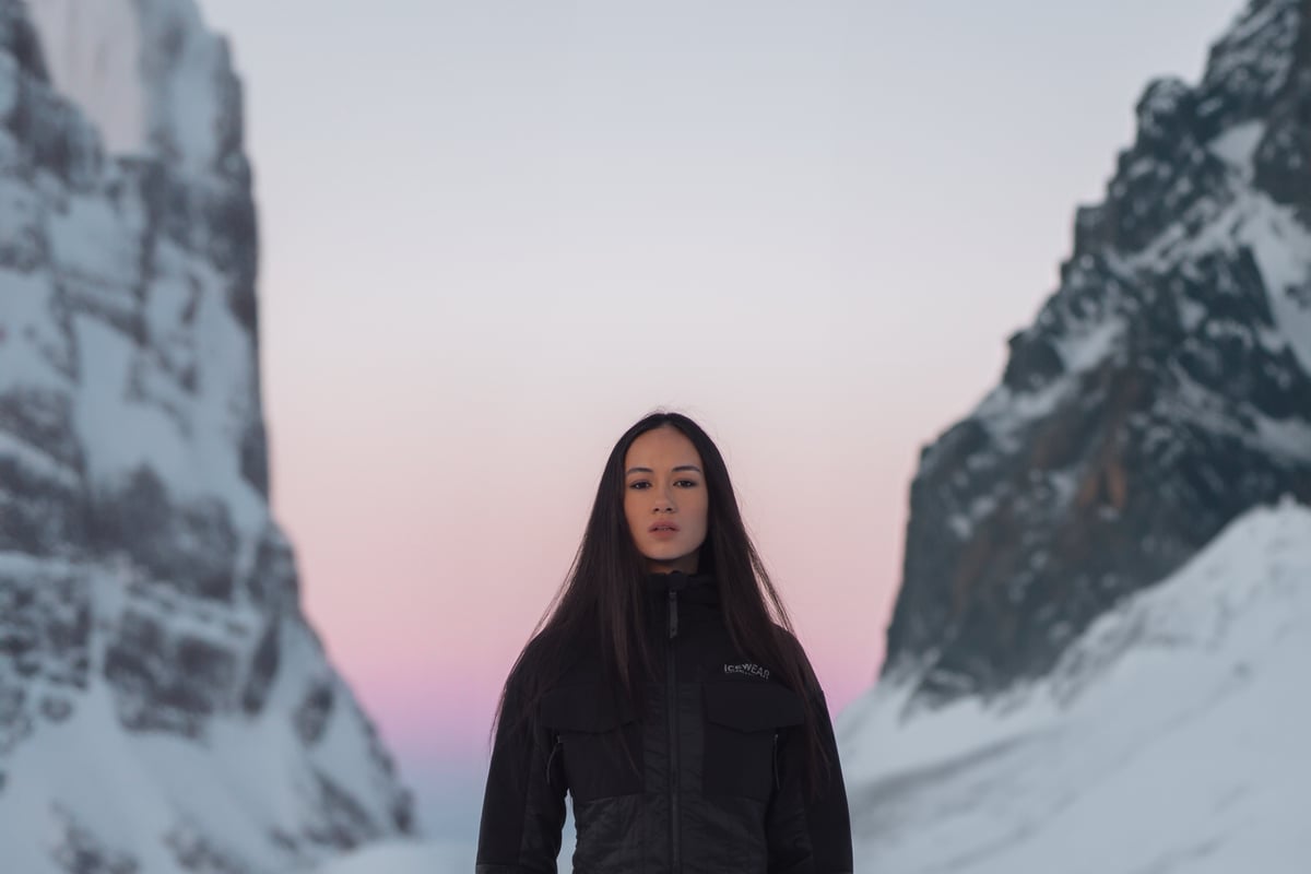 woman up in the mountains with snow