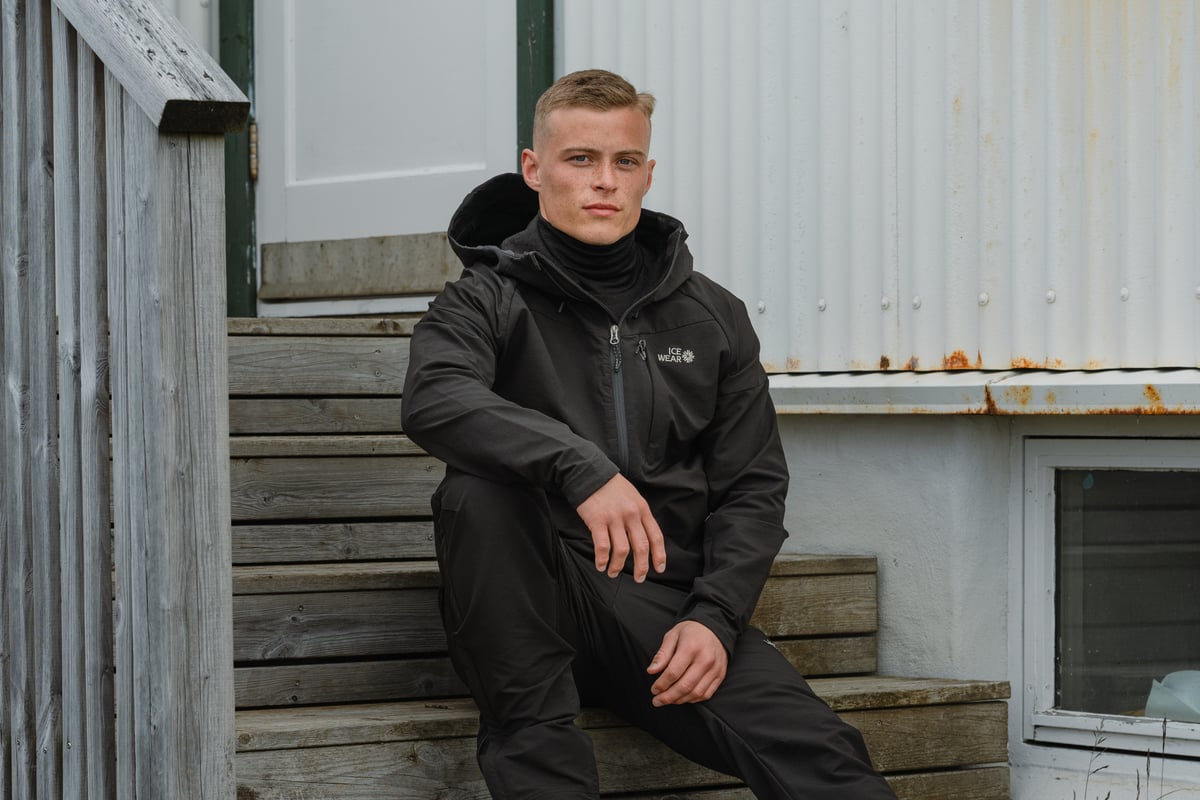 A man sitting on the steps outside an old house