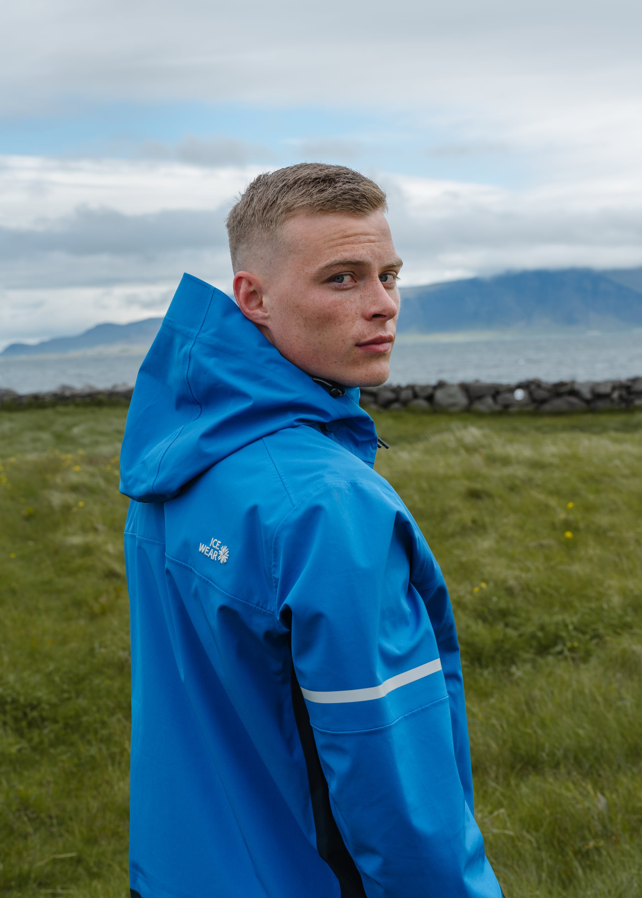 man-blue-jacket-ocean-grass-1.jpeg