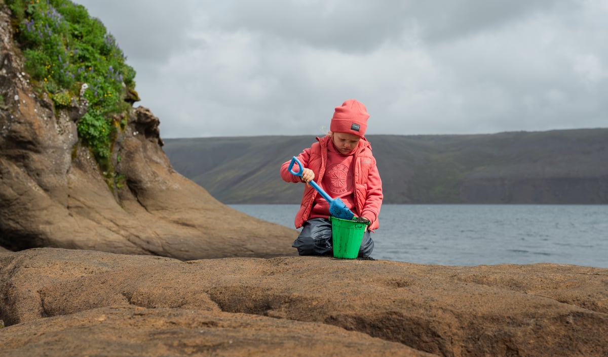 Boy shoveling in a bucket