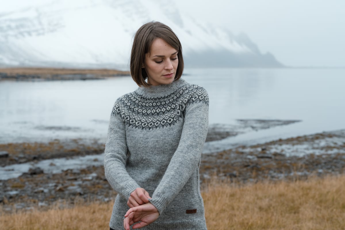 woman with sea and mountain behind her