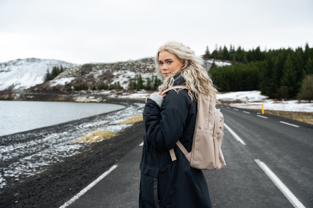 woman walking in middle of the road