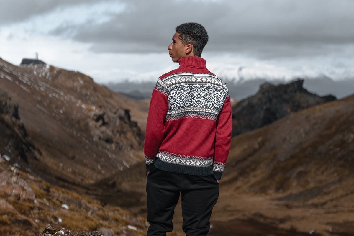 man wearing Norwegian sweater called Oslo up in the mountains