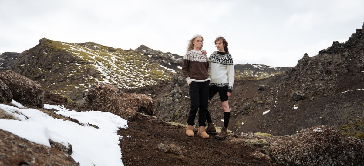 Women hiking in Icelandic wool jumpers with sheep pattern.