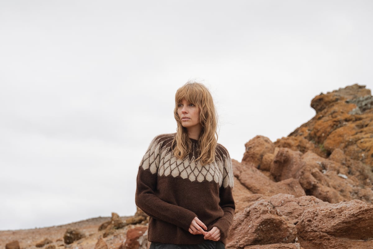 woman standing next to rocks