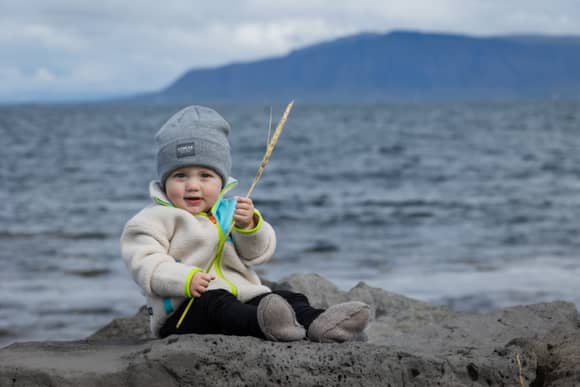 kid sitting by the Icelandic sea