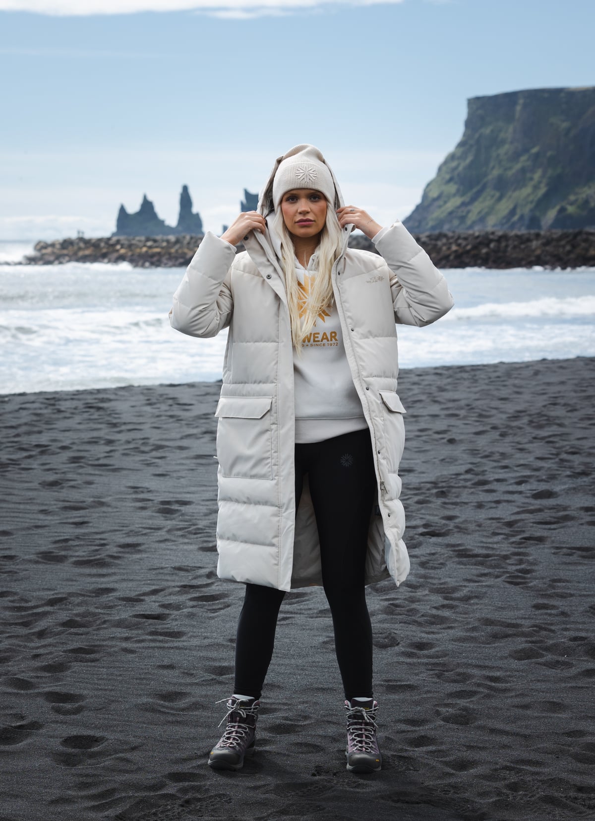 woman-white-long-jacket-blackbeach.jpeg