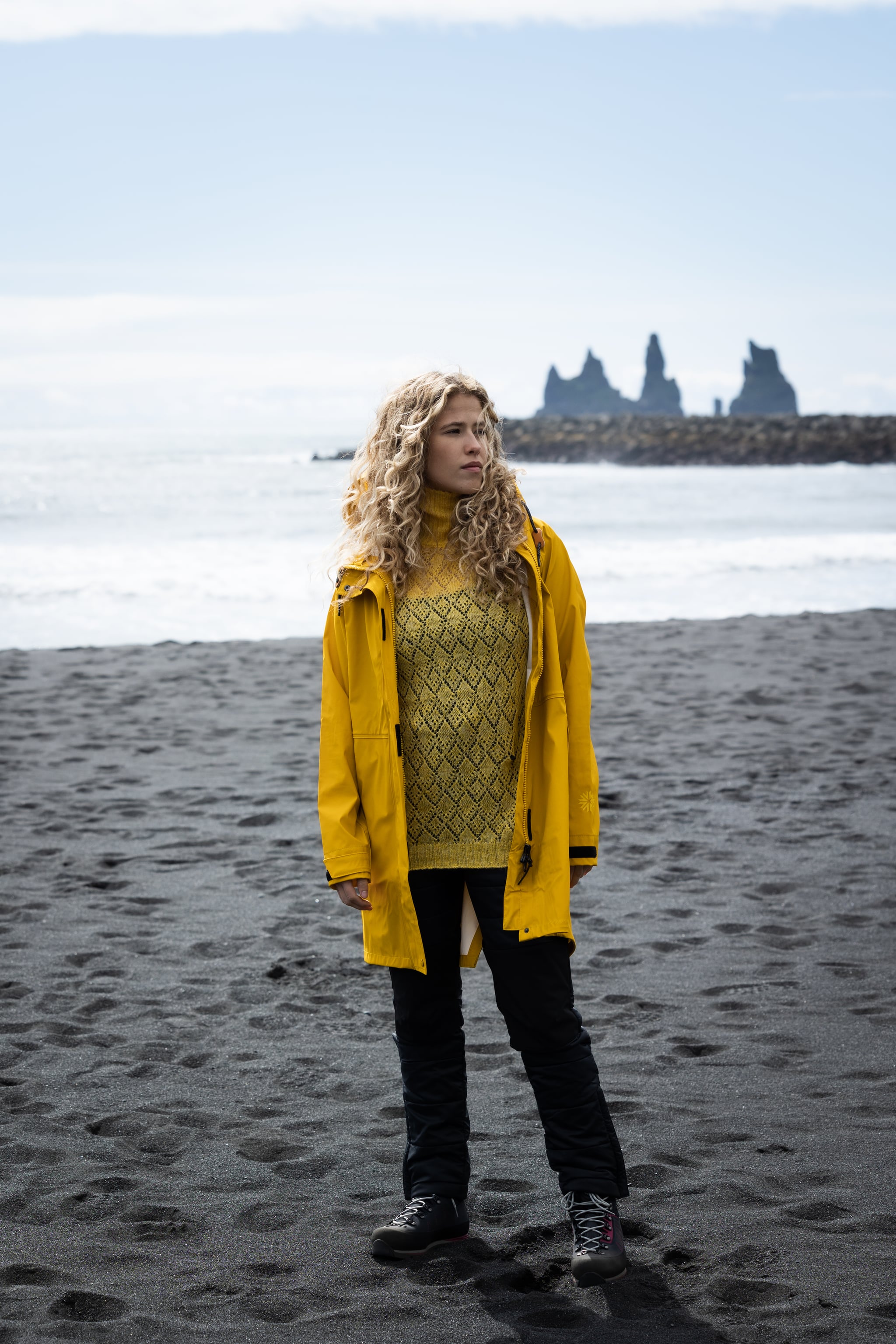 woman-yellow-rainjacket-sweater-blackbeach.jpeg