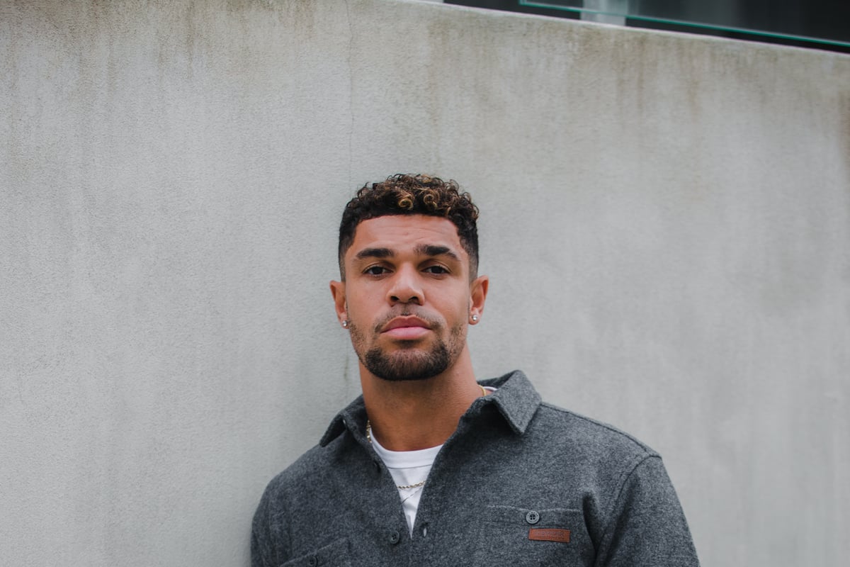 man standing next to wall in Reykjavík city center