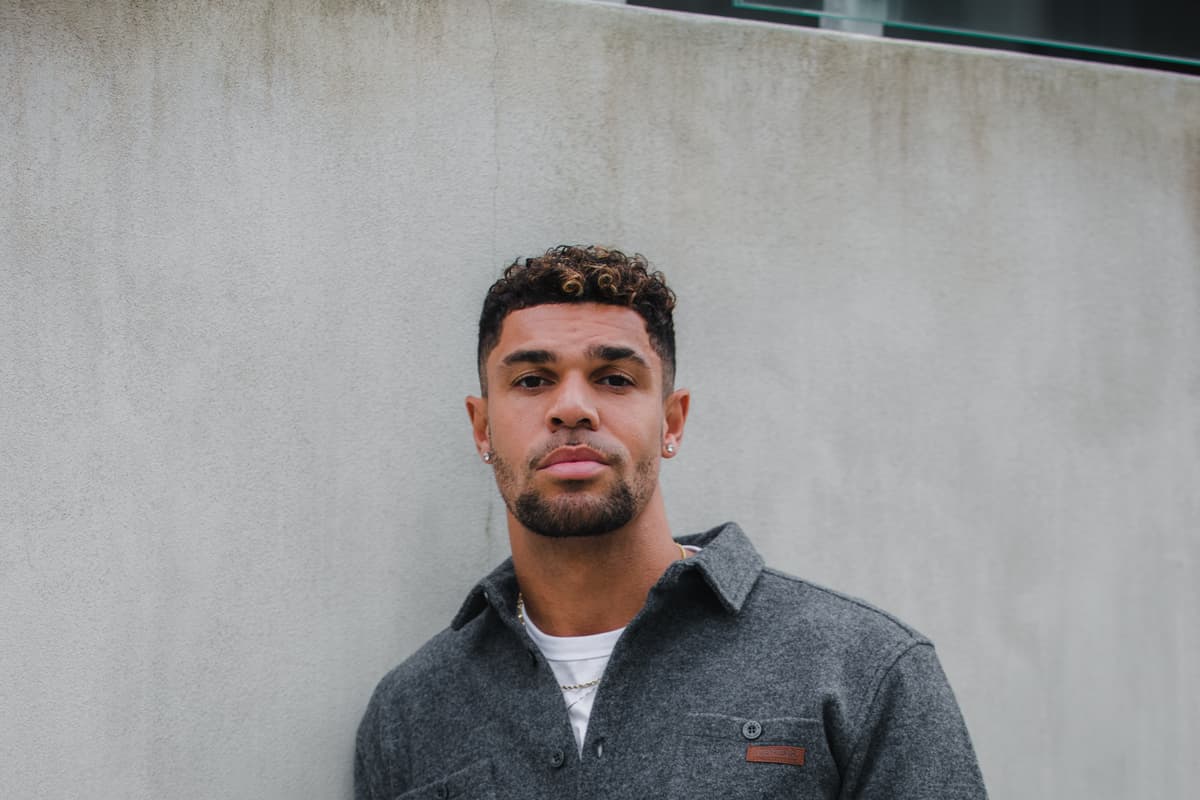 man standing next to wall in Reykjavík city center