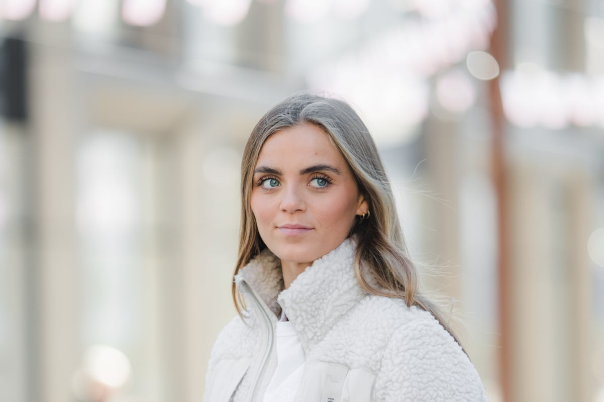 woman wearing long fleece coat in city center Reykjavík