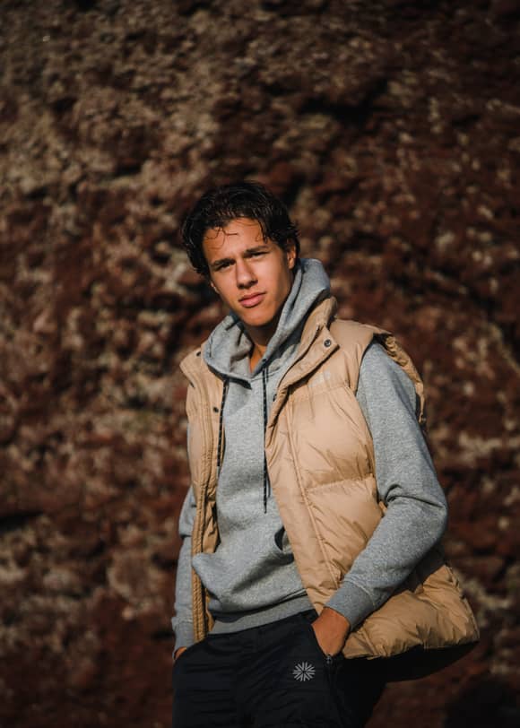man in a hoodie and vest
