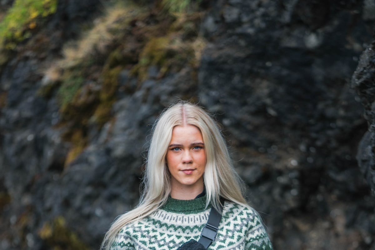 woman in Icelandic wool sweater in lava nature in Iceland