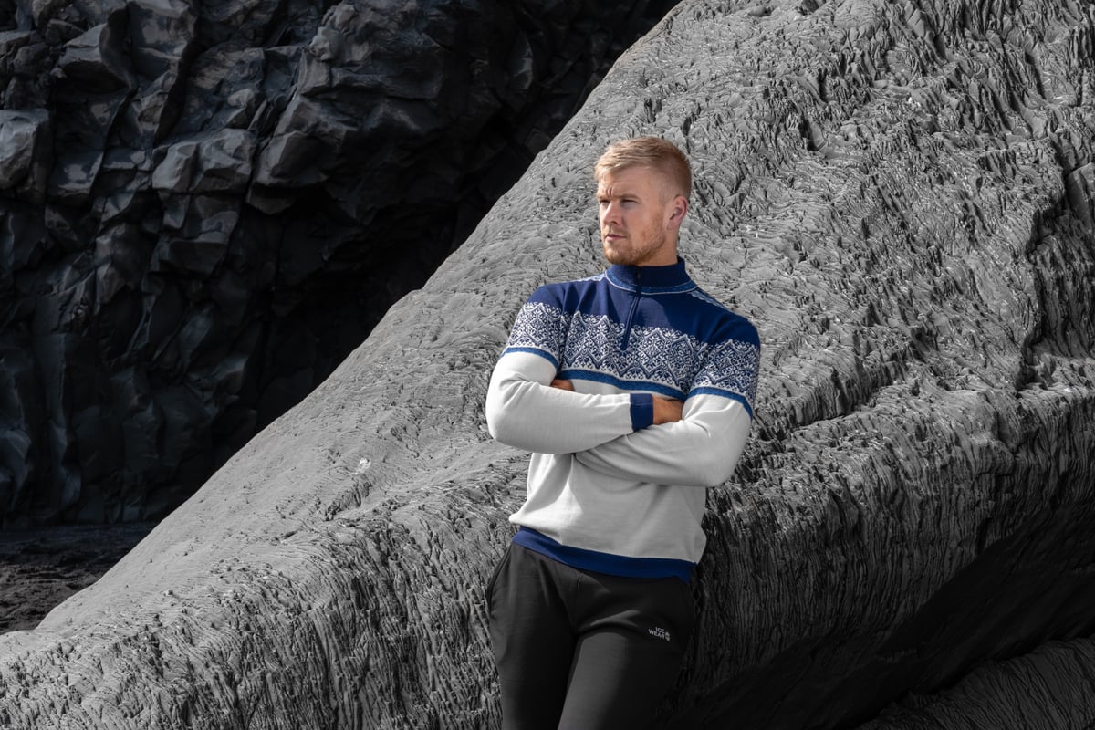 man standing next to cliff
