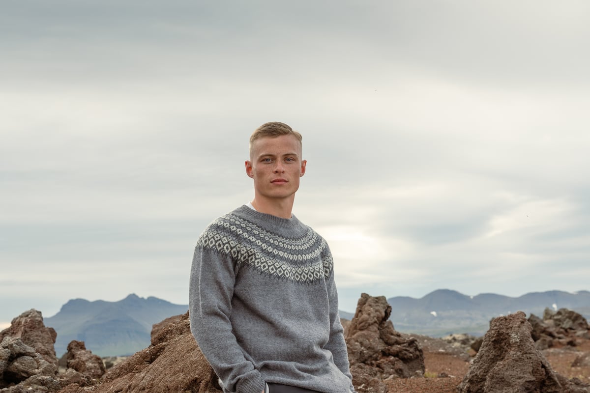 man sitting on a lava cliff