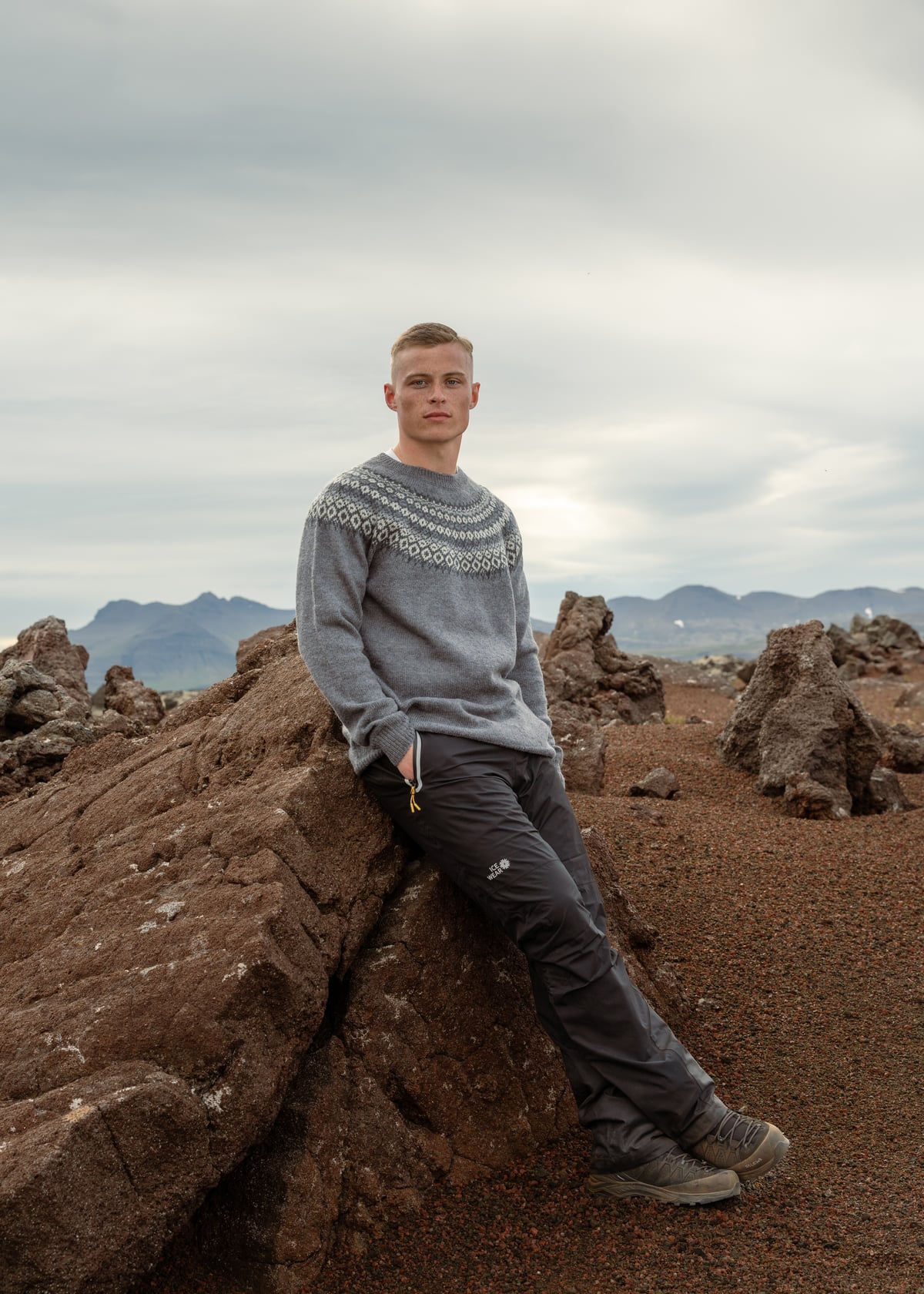man sitting on a lava cliff