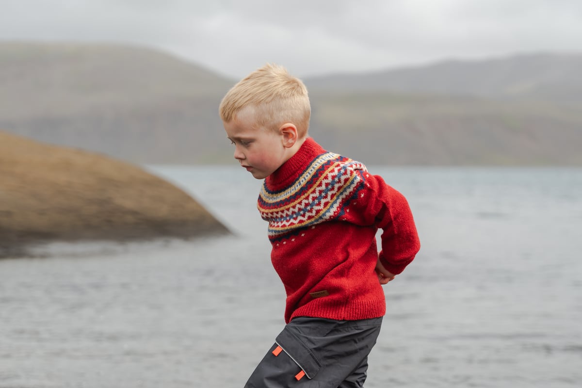 boy running close to the lake
