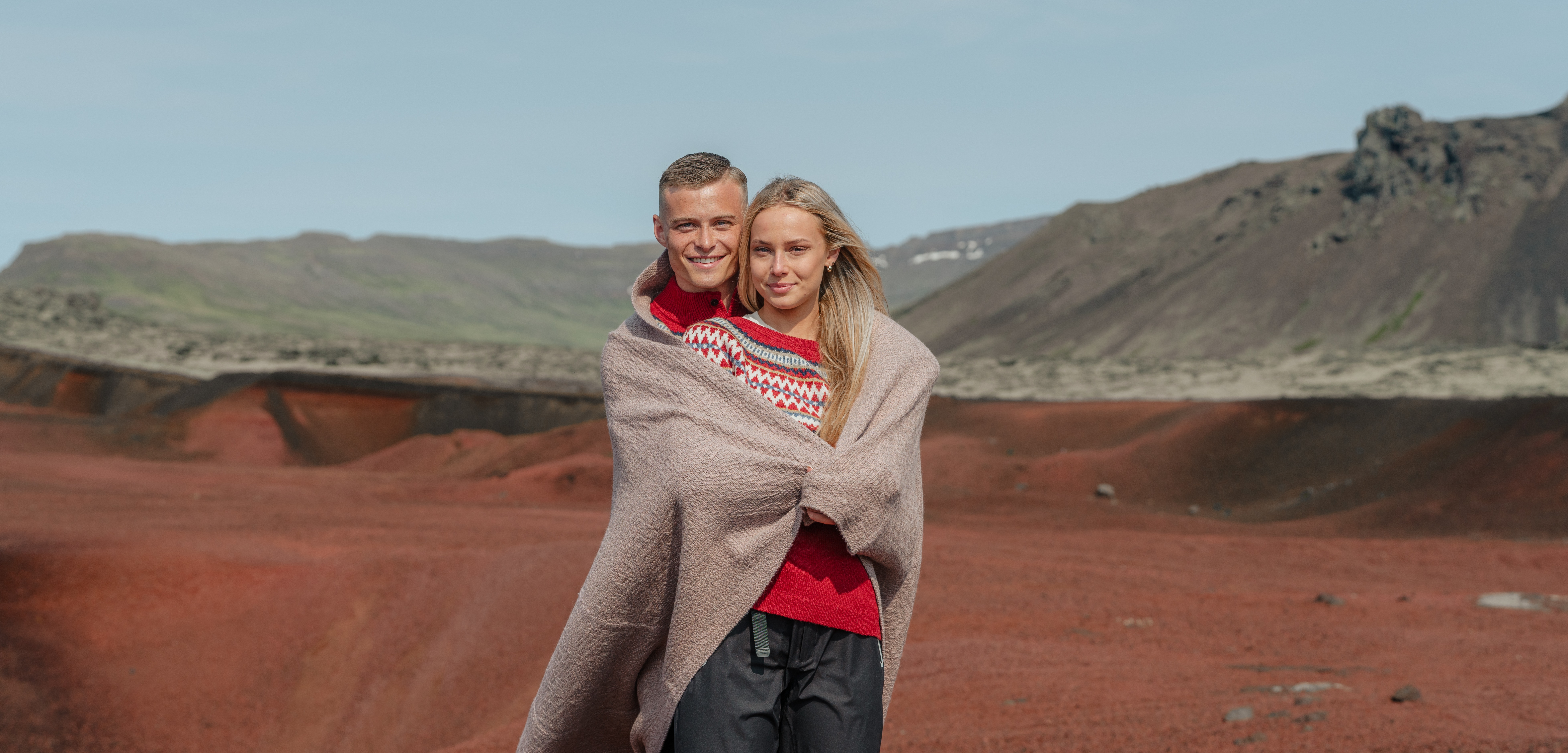 A couple with a blanket around them.