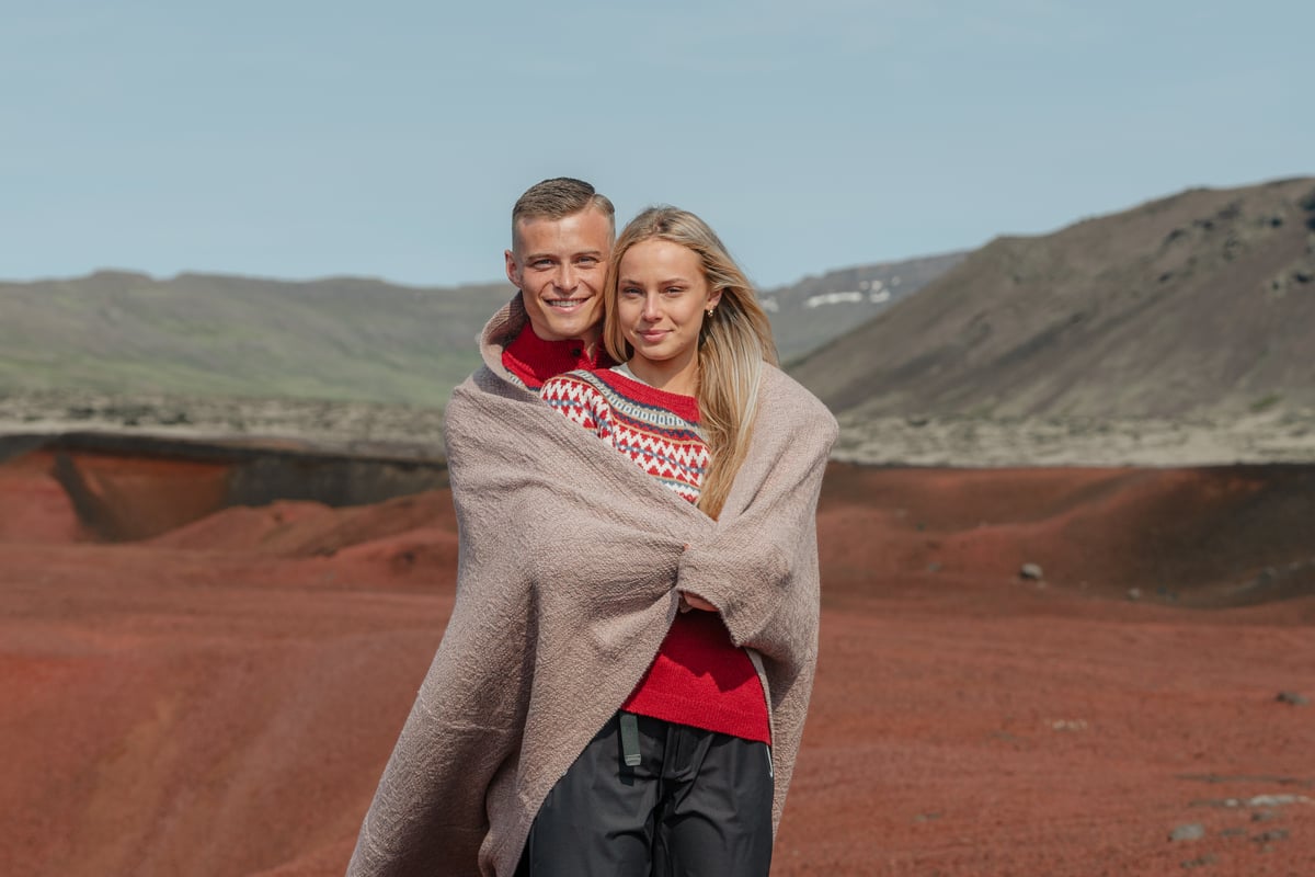 A couple with a blanket around them.