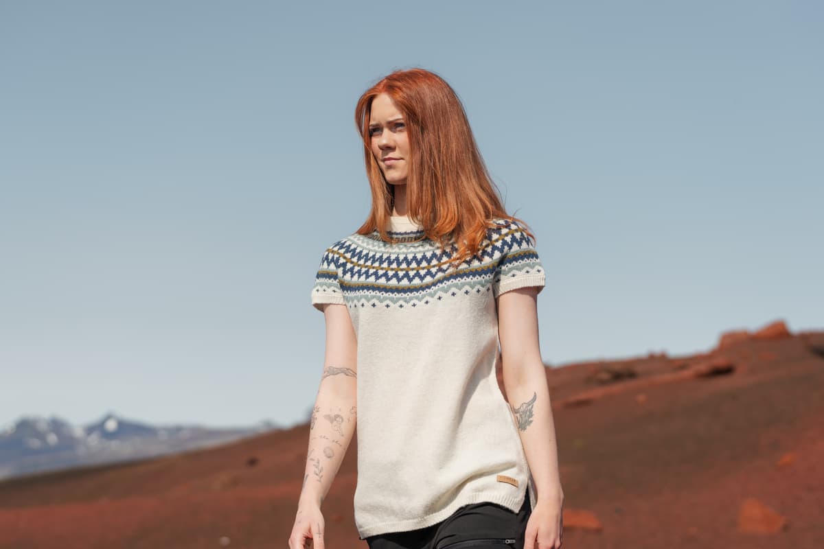 woman wearing sweater vest in a warm summer day in Icelandi